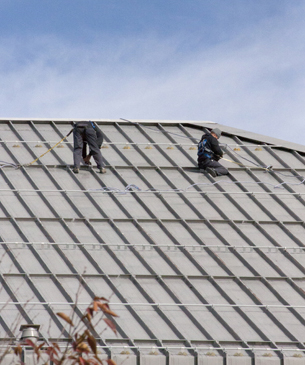 SRM crew on a standing-seam metal roof